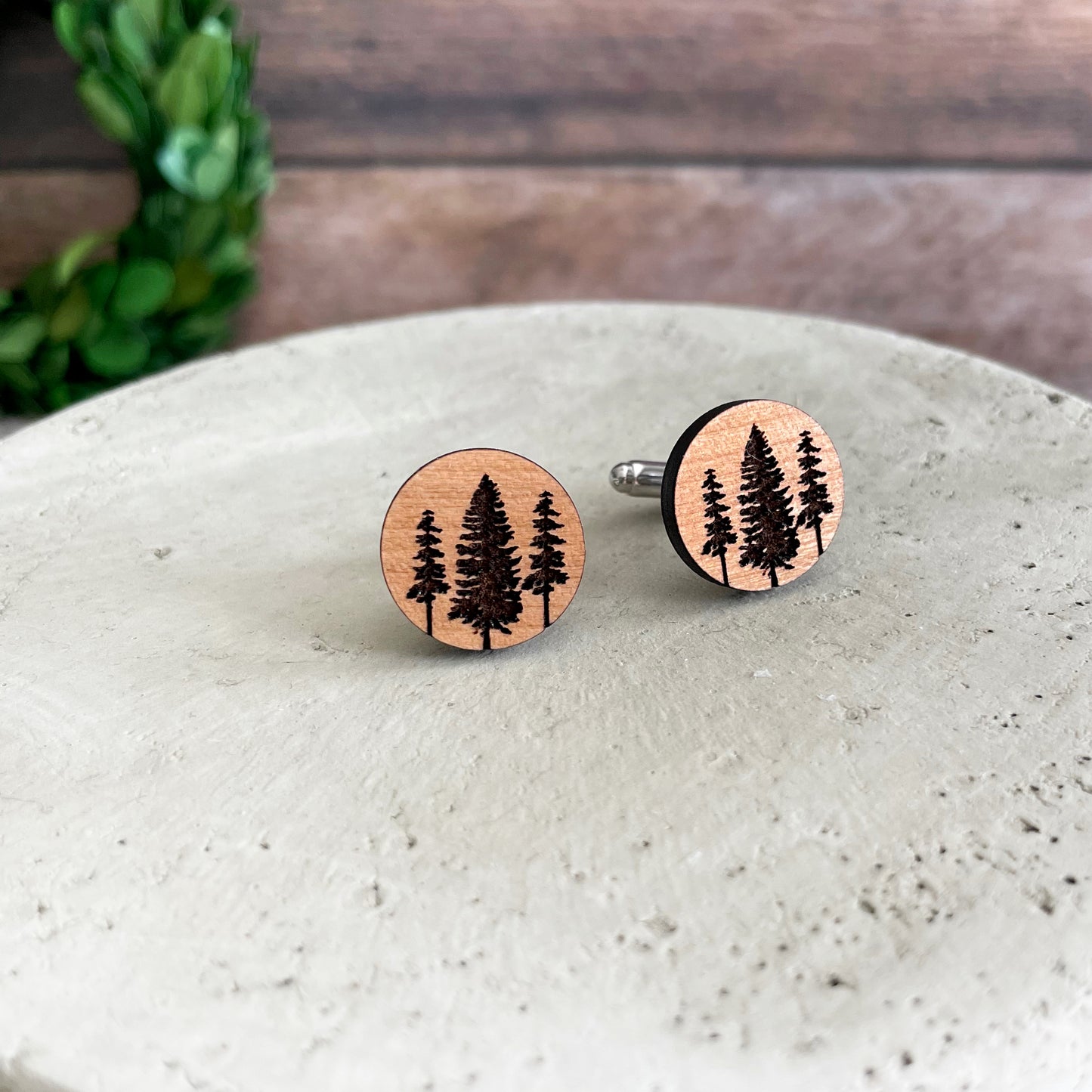 Engraved wood cufflinks with tall pine trees,