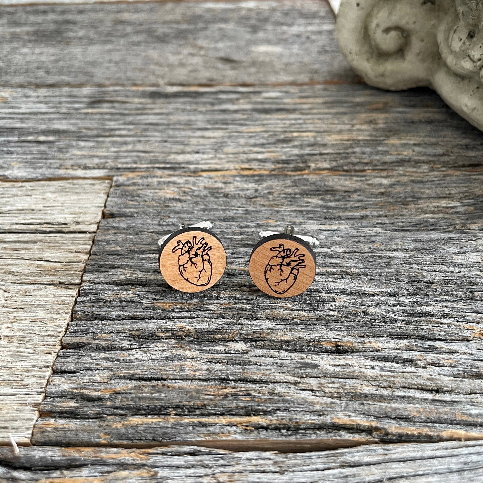 Laser engraved wooden cufflinks with a drawing of a heart