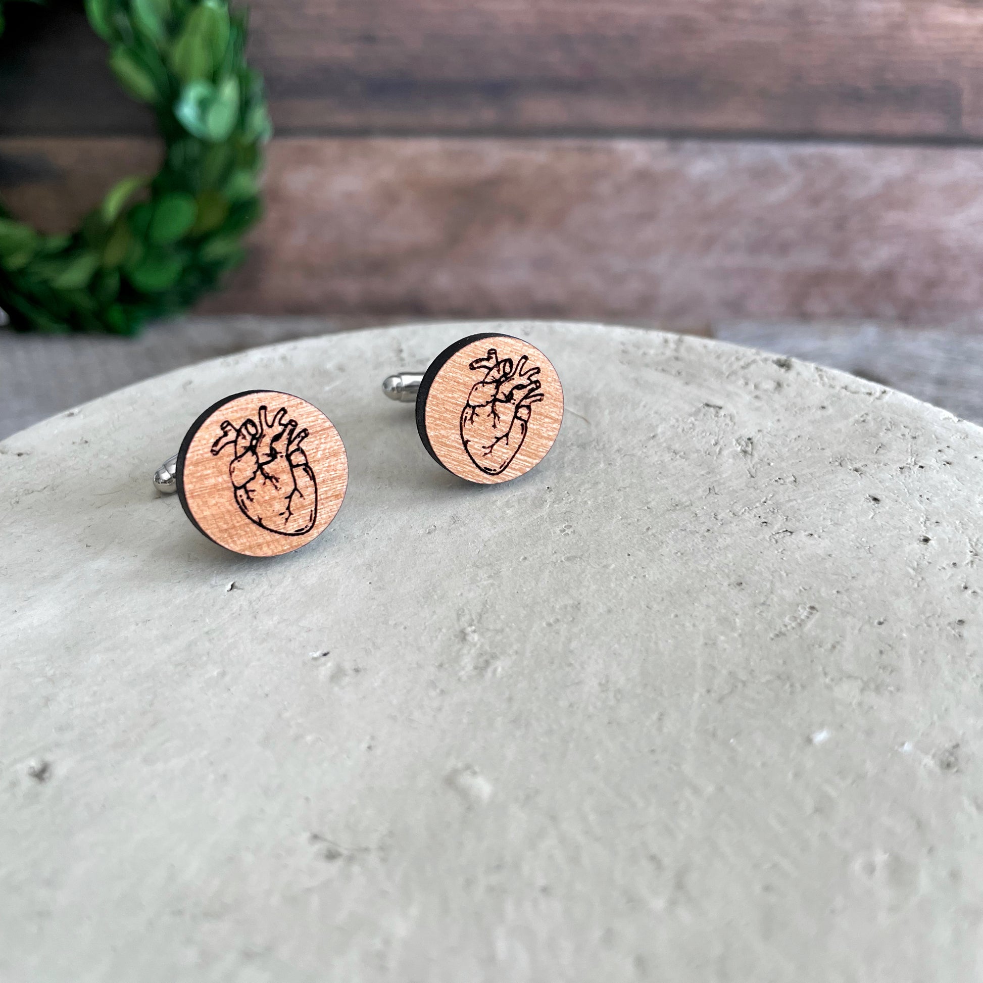 Laser engraved wooden cufflinks with a drawing of a heart