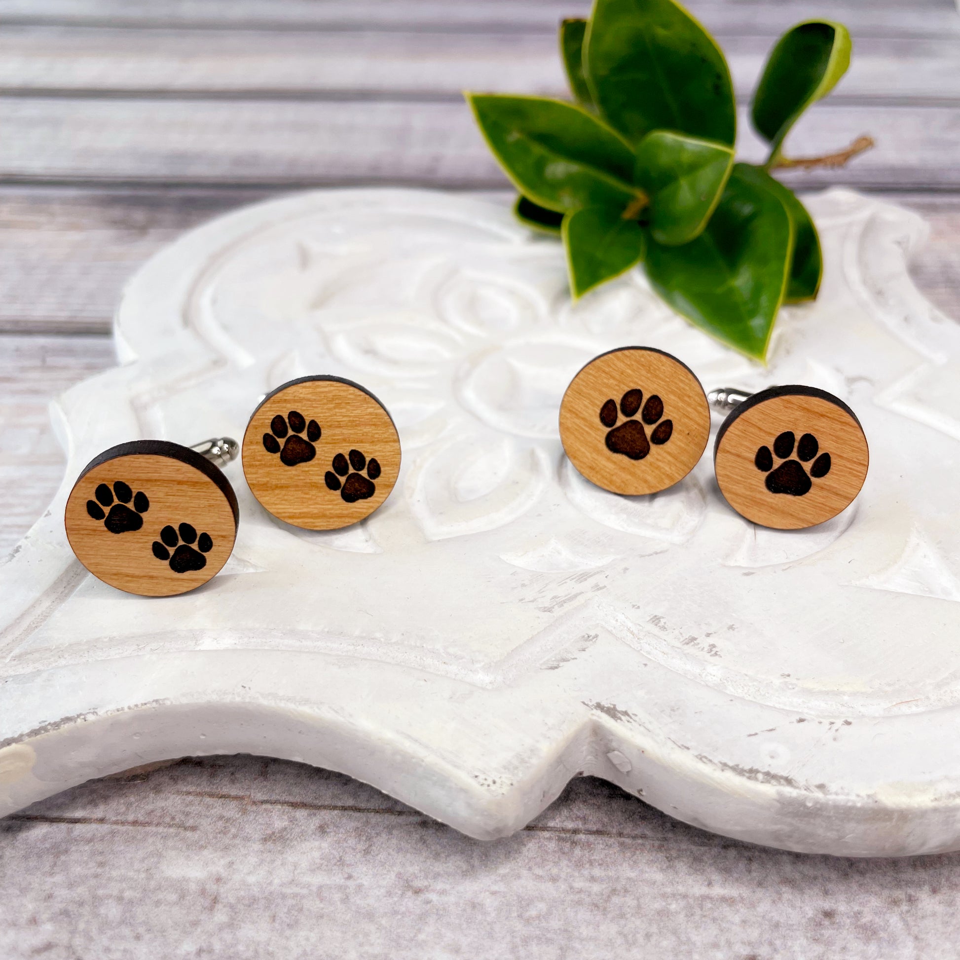 Engraved wooden cufflinks with a paw print